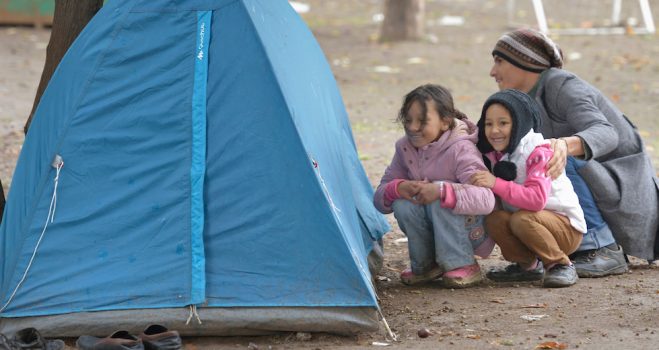 Afghan refugees play hide and seek behind a tent in a city park in Belgrade, Serbia. The park has filled with refugees from several countries stopping over on their way to Germany, Sweden, Holland, and elsewhere. The ACT Alliance has provided critical support for refugee and migrant families here and in other places along their journey.